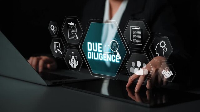 Hands typing on a laptop with a futuristic display of due diligence icons and symbols representing business compliance and data analysis in a dark environment Sigmoid