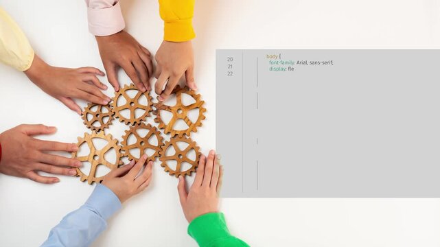 A close-up of diverse hands working together with wooden gears and coding elements, showcasing collaboration and innovation in a business or technology environment. Raster