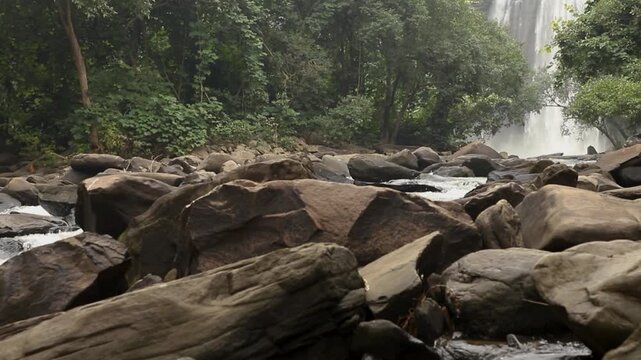 Majestic Waterfall Cascading Down Rocky Cliff in Lush Green Forest - Zoom in to the lower part of waterfall.