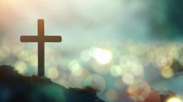 Silhouette of a Christian cross on a hill with a bright, ethereal sky and bokeh lights in the background, symbolizing hope and spirituality.