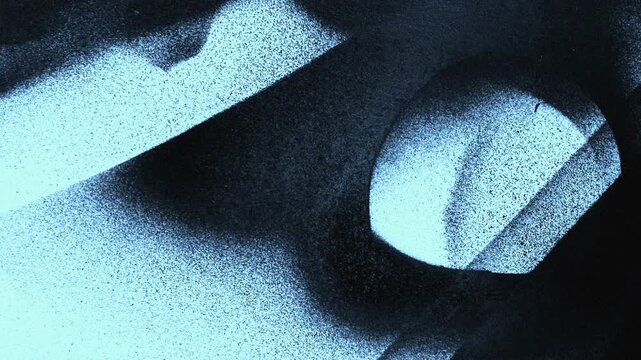 Spray paint mist on black background. Aerosol paint particles floating in dark studio.