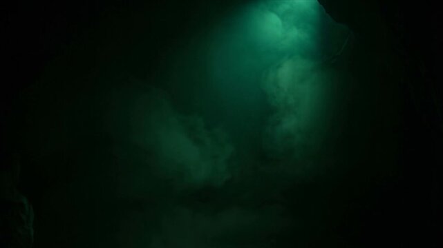 Green Volumetric Mist and Fog Descending in Dark Cave Atmosphere