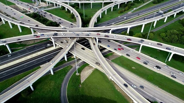 Aerial view of a complex highway interchange with traffic.