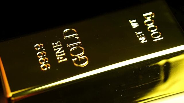 Close-up of a shiny gold bar with inscriptions.