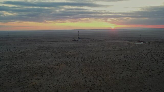 Soft sunset light across desert horizon with cloudy sky.