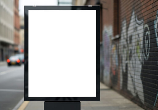 Blank vertical street poster billboard mockup on city sidewalk background