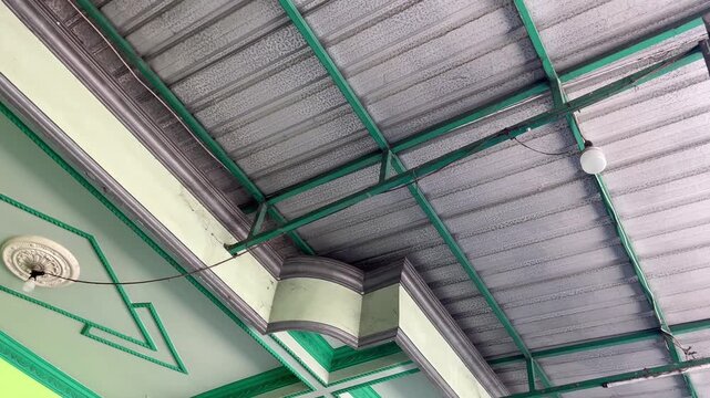 Close-up of Galvalume Roofing Sheets and Green Steel Frame