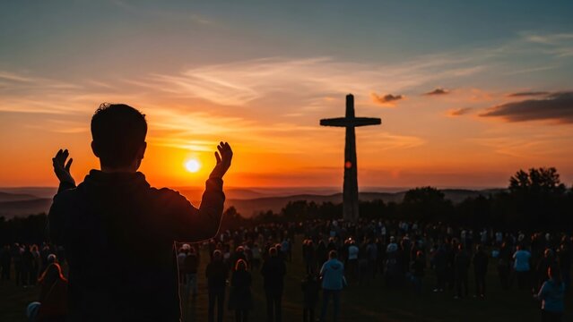 People gathered at sunset in front of a large cross during a religious outdoor service or prayer event capturing spiritual devotion and community unity at dusk
