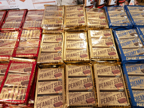 LANGKAWI, MALAYSIA - MAR 18, 2026: Assorted Whittaker's chocolate bars including Peanut Slab, Almond Gold, and Creamy Milk on display.