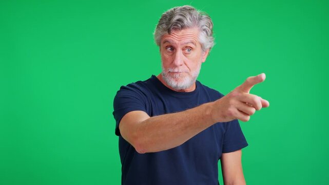 Mature man pointing his finger on green screen