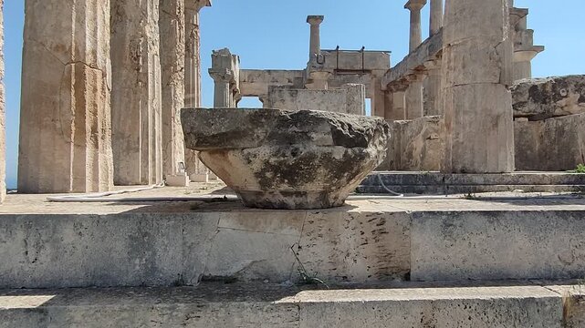 The Temple of Aphaia on Aegina island, Greece, a well preserved temple featuring impressive Doric columns and intricate sculptural details from around 500 BCE, overlooking the the Saronic Gulf