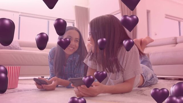 Teenager and adult lying on rug, glancing at phones, spawning social purple hearts covering faces