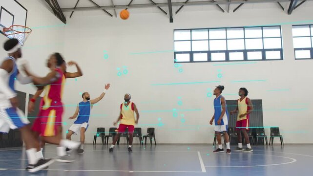 Basketball players on gym court, blue guard driving and passing, red shooter rising, seeking basket