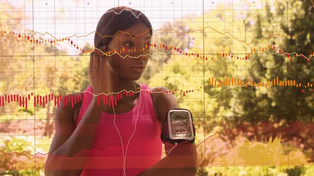 Runner tapping armband adjusting earbud in sunlit park preparing workout as animated graphs overlay
