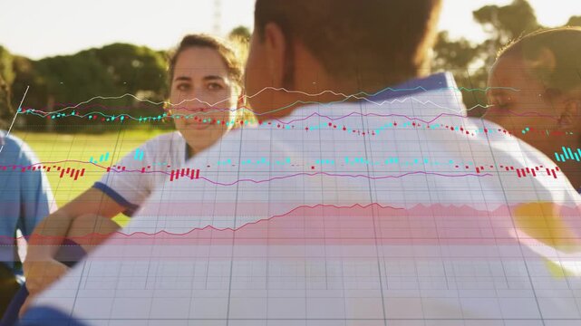 Camera panning rightward women soccer team sitting on grass listening as charts covering players
