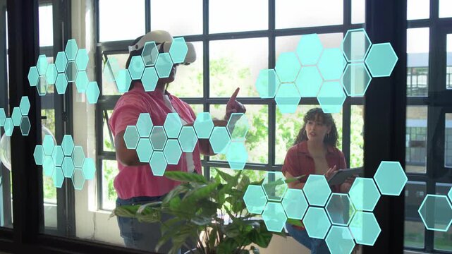 Woman with VR headset raising hands, manipulating hex UI for tech testing, observer noting tablet