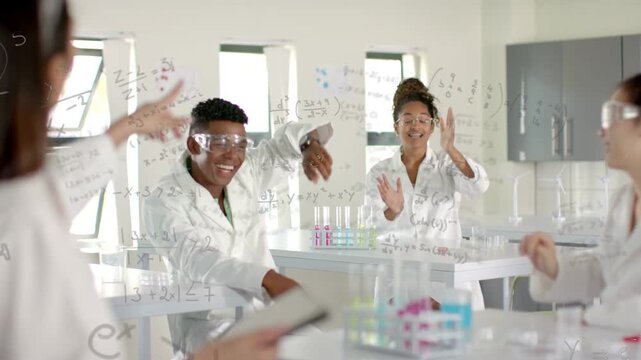 Offframe pointing tablet cueing lab raising, clapping as center student presenting formulas on pane