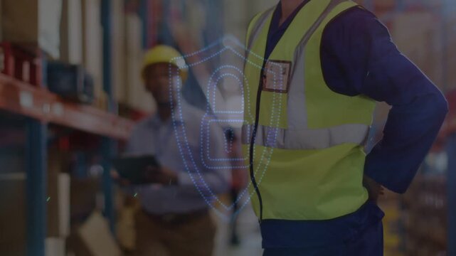 Worker shifting in warehouse, tablet coworker glancing up activating shield lock checking security
