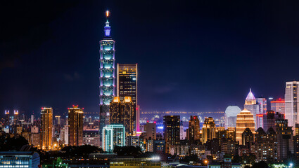 Fototapeta premium Taipei 101 Skyscraper and Modern City Skyline at Night with Illuminated Buildings