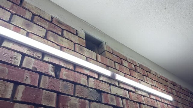 brick wall with exterior ventilation shaft near roof edge in close up, building airflow and exhaust system concept