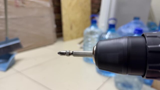 electric screwdriver rotating in close up, cordless power tool demonstrating spinning motion