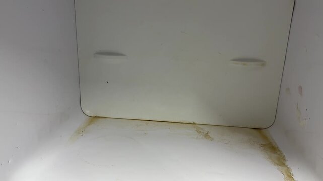 empty freezer compartment inside old refrigerator, worn interior of vintage cooling appliance close up