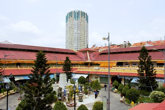 Ho Chi Minh City, Vietnam - April 2026: Courtyard area of Binh Tay Market, also known as Cholon Market, with a modern high-rise building in the background in Ho Chi Minh City, Vietnam.