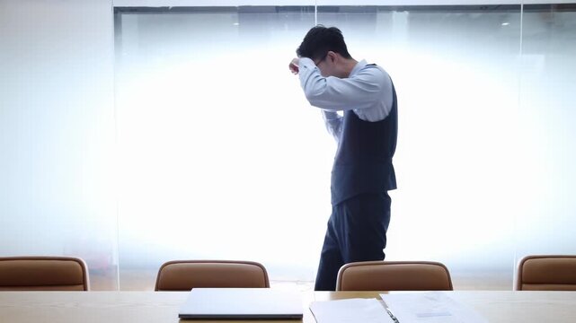 Tired angry office worker businessman shouting arguing quarrel conflict screaming while using cellphone mobile phone for talking with client, business partners in meeting room