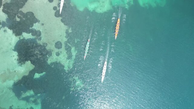 Top Down Aerial View of Rowing Boats Competing in a Race on Turquoise Sea. High quality 4k footage