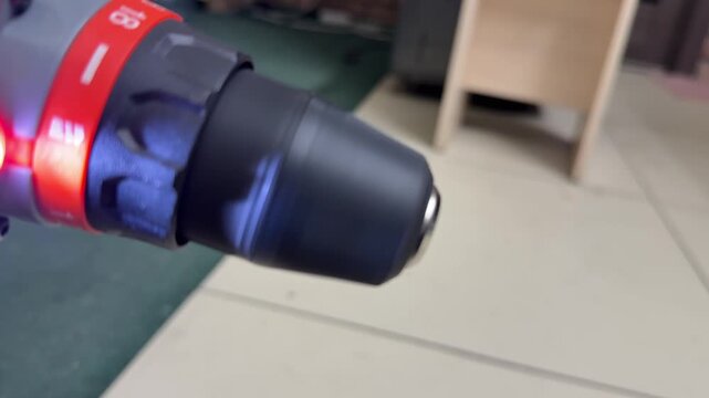 front view of cordless drill rotating with led light, power tool working in close up