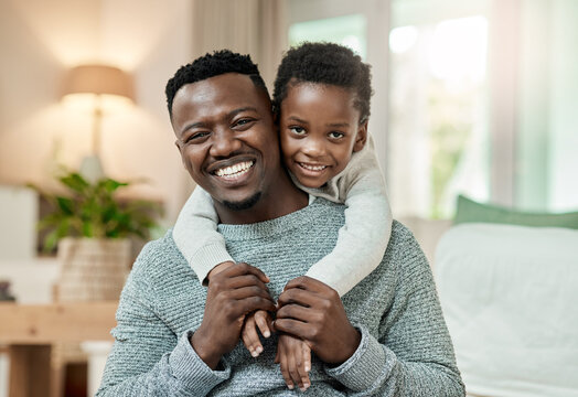 Portrait, dad and smile with child in lounge, piggyback and bonding with son and connection in home. Happy, family and affection for kid in house, childcare or black man with boy and support on break