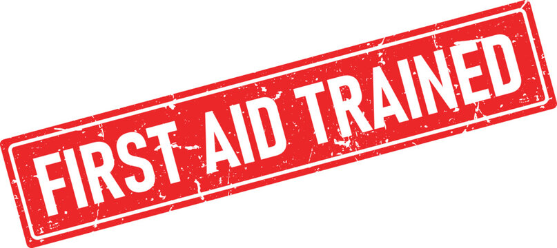 Distressed red rubber stamp impression with the words First Aid Trained in white
