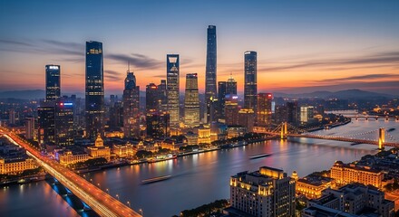 Fototapeta premium Illuminated city skyline at dusk, with a river and bridges reflecting the golden lights