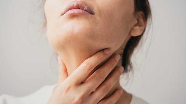 Young woman suffering from sore throat