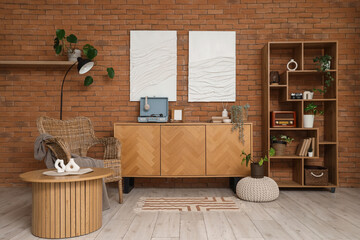 Interior of living room with record player on commode, armchair and shelf unit © Pixel-Shot
