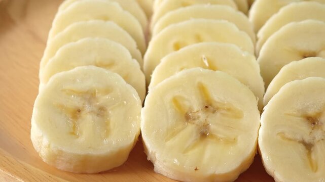 close-up captures the creamy allure of sliced bananas. Each uniform piece unveils a soft	