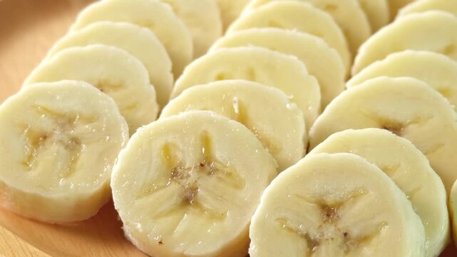 close-up captures the creamy allure of sliced bananas. Each uniform piece unveils a soft	