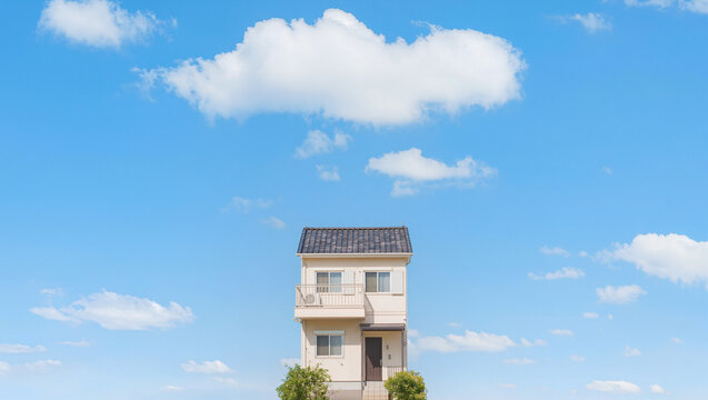 Small Family House Under Blue Sky with Fluffy White Clouds