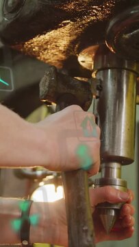 Vertical video: Shop machinist tapping handle seating swapping bit as green HUD guiding tool change