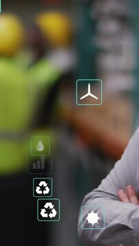 Vertical video: Mgr folding arms in warehouse camera panning icons floating over team with KPIs