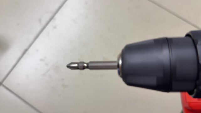 electric screwdriver rotating in close up, cordless power tool demonstrating spinning motion