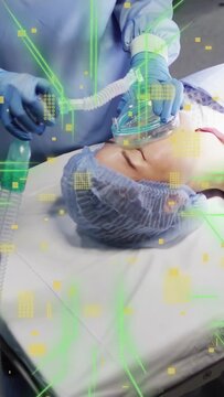 Vertical video: Medical nurse placing O2 mask, pumping bag to oxygenate, green overlay appearing