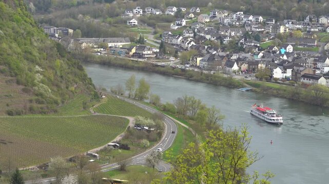 Aerial shot of a river boat cruising in Rhine river near Cochem, Germany