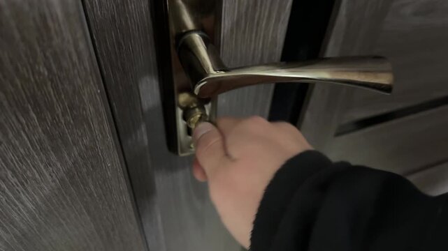 Close up of hand turning key in door lock, unlocking mechanism and gaining access, everyday action and security interaction indoors