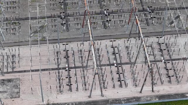Top-down drone shot of high-voltage electrical substation and transmission infrastructure at power plant