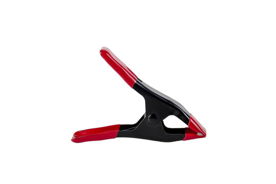 Black plastic spring clamp and hand isolated on transparent background.