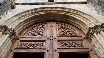 Obraz premium Ornate Wooden Church Doorway with Intricate Stone Archway