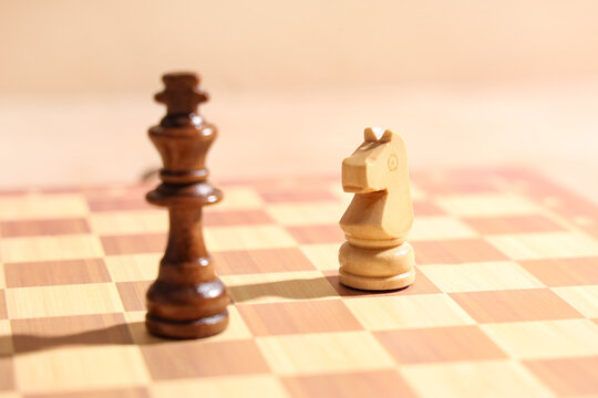 Chess pieces on game board, closeup