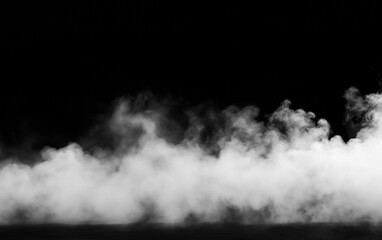 Fototapeta premium White fog or smoke overlay effect drifting across the lower part of a black background, creating an atmospheric mist with soft texture, dramatic contrast, and ample copy space.