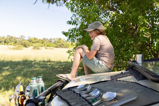 young boy sitting in safari vehicle, Okavango Delta, Botswana, Africa